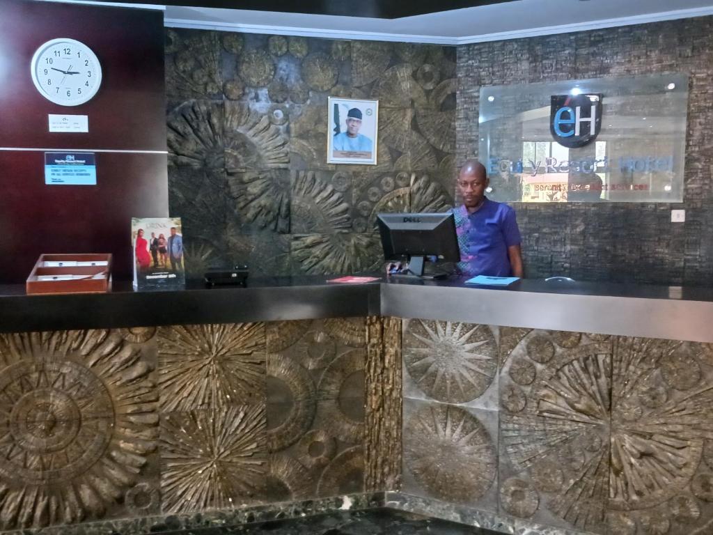 a man standing at the counter of a restaurant at Equity resort hotel ijebu in Ijebu Ode