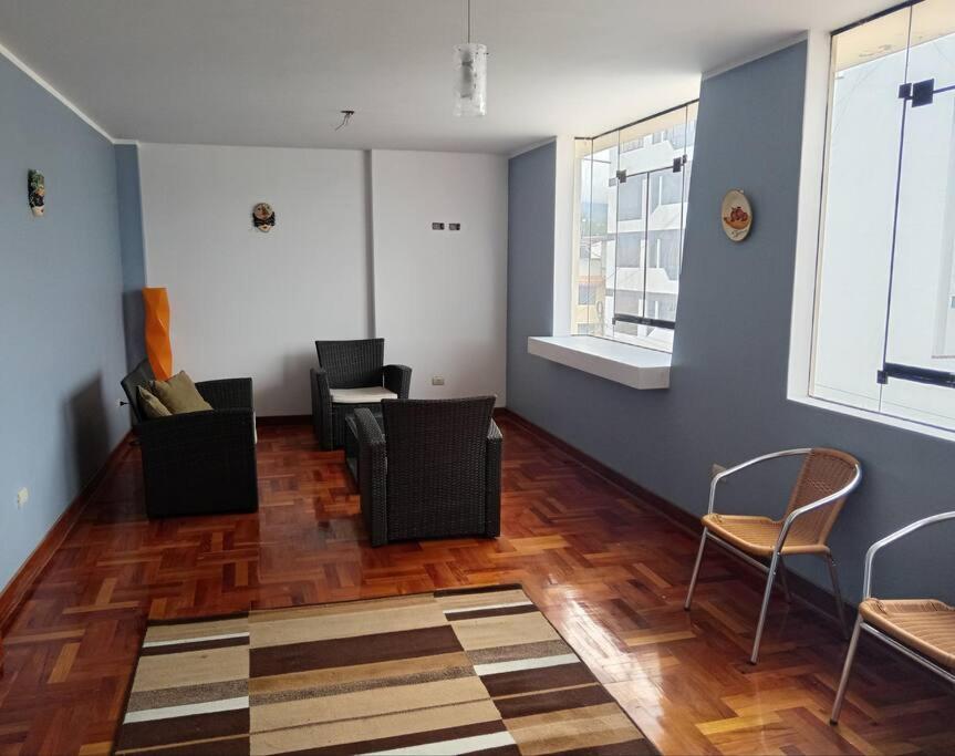 sala de estar con sillas y pared azul en Departamento Cielo Cajamarquino, en Cajamarca
