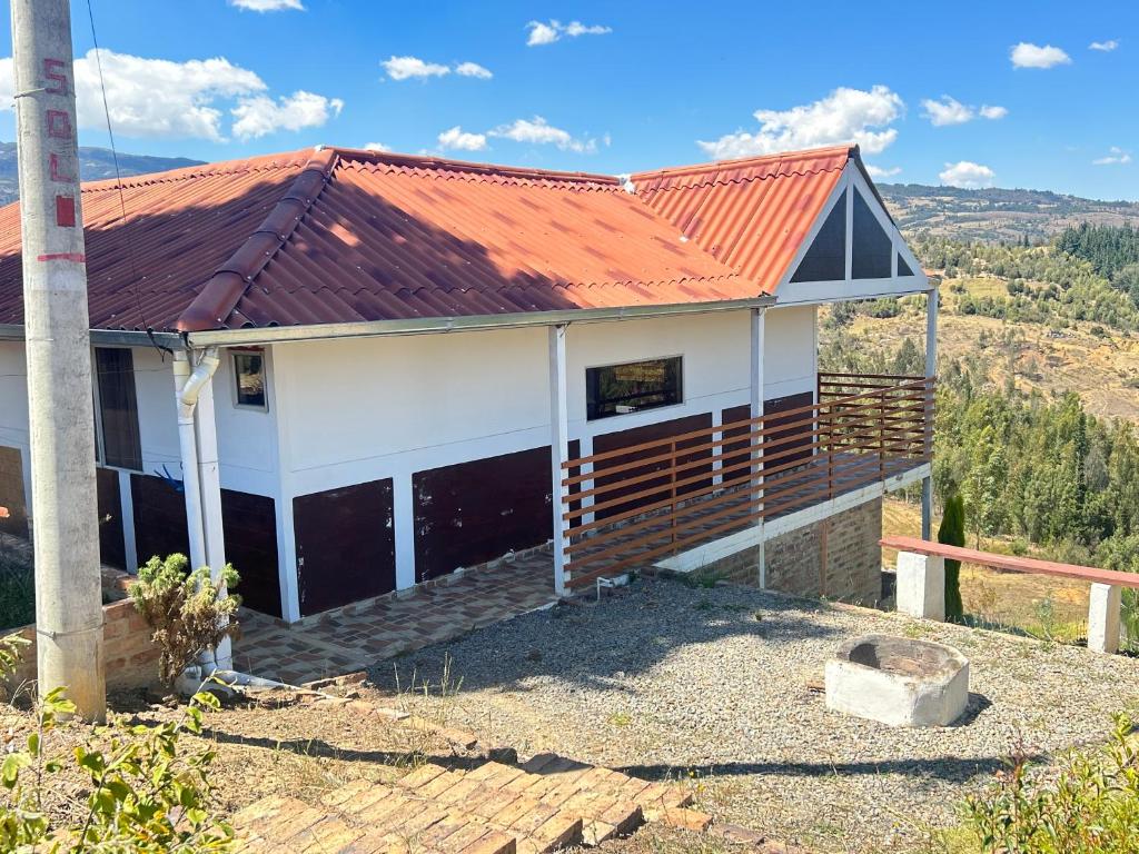 a house with an orange roof at Chalet Familiar Full equipado! Jacuzzi privado 30 minutos gratis! in Sogamoso