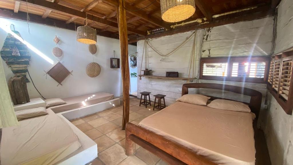 a bedroom with a bed and a tub in a room at Morada Venturi in Atins
