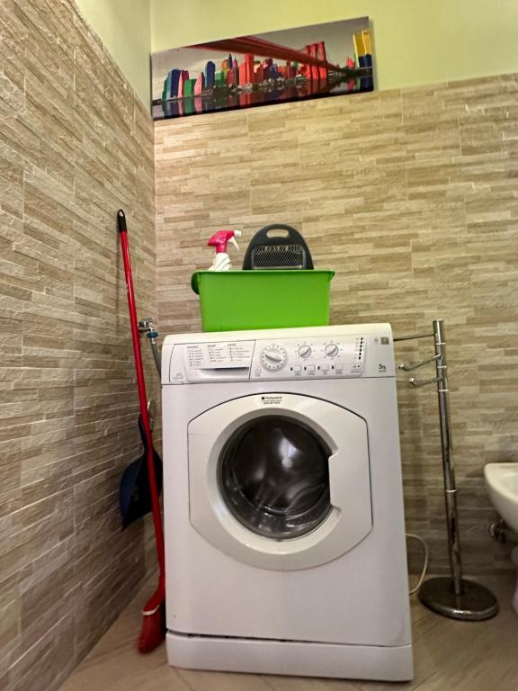 a washing machine with a bucket on top of it at Casa del sasso in Bergeggi