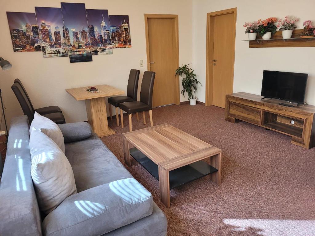 a living room with a couch and a table at Apartment - Gästewohnung - Unterkunft Monteure in Chemnitz