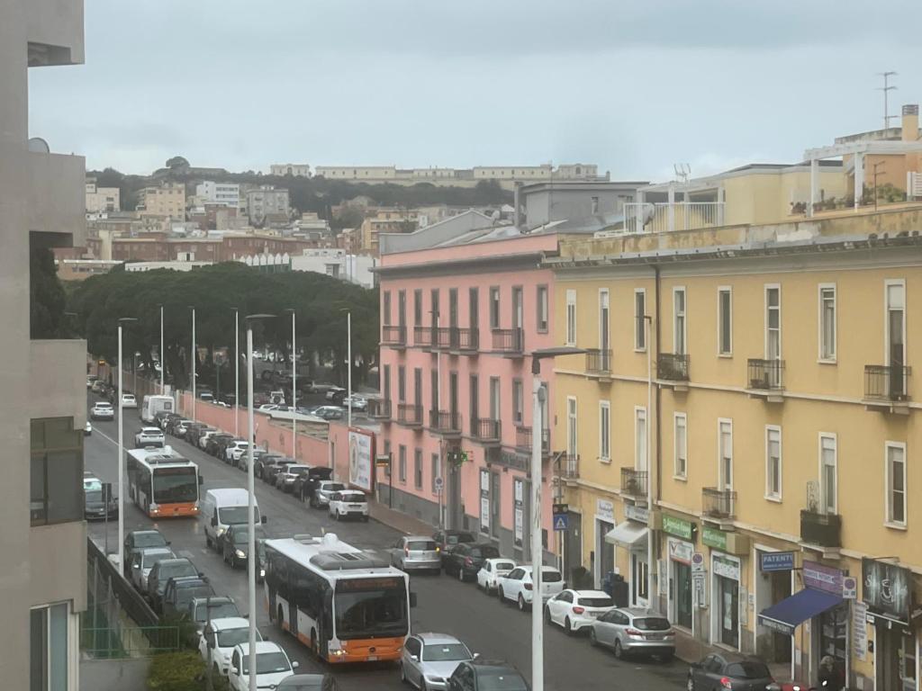 a city street with cars and buses and buildings at Appartamento da Carmela in Cagliari