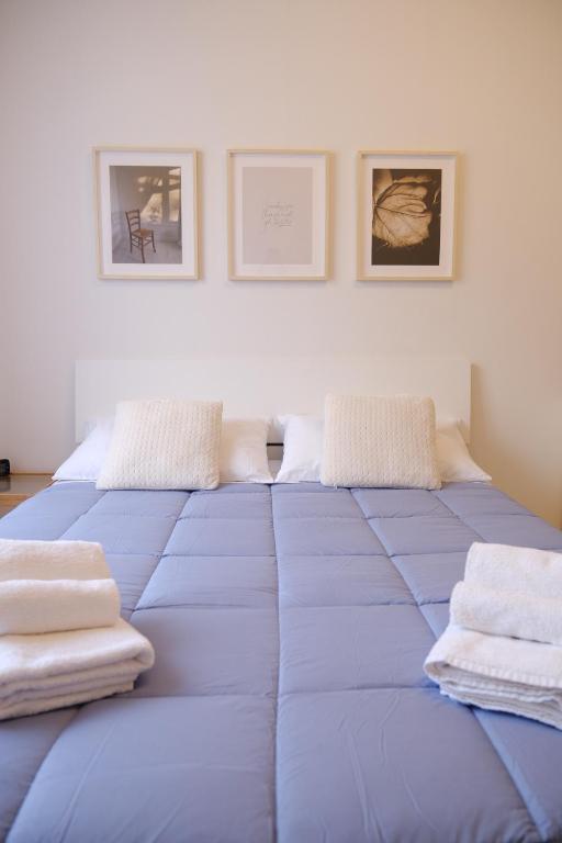 a large blue bed with towels on top of it at Politecnico Bovisa university apartment in Milan