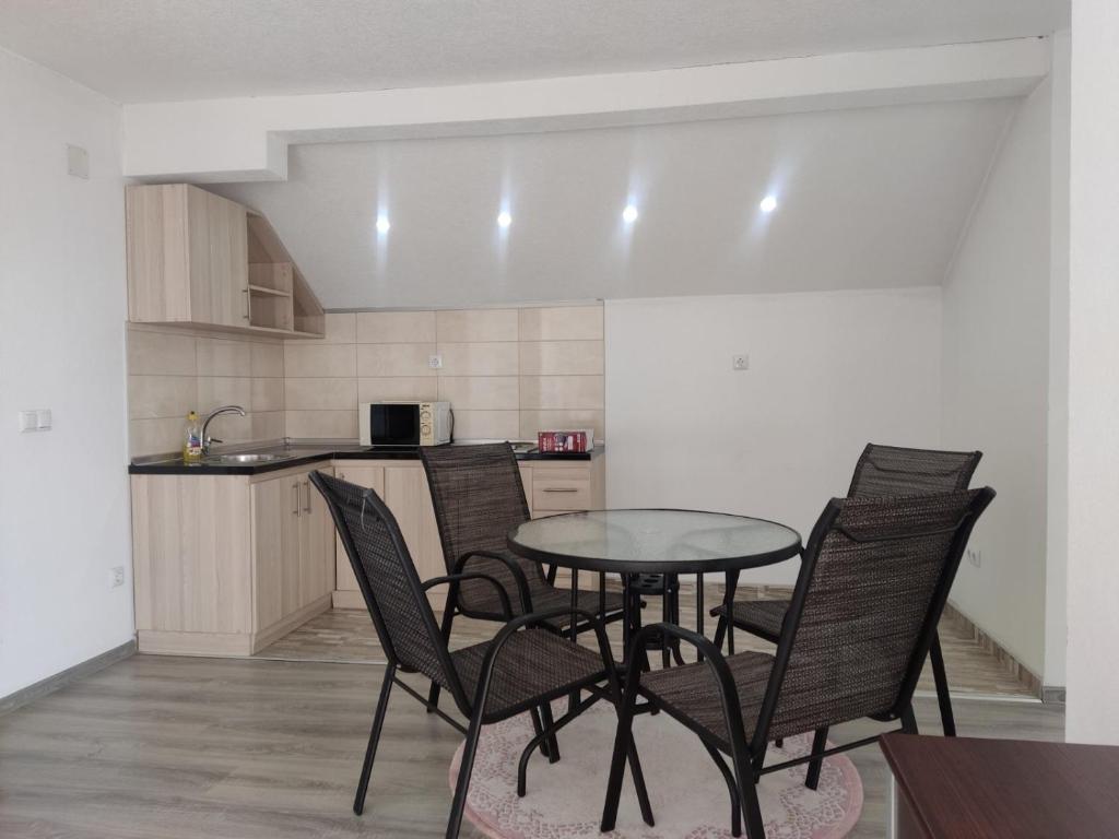 a kitchen with a table and chairs in a room at Selma in Vogošća