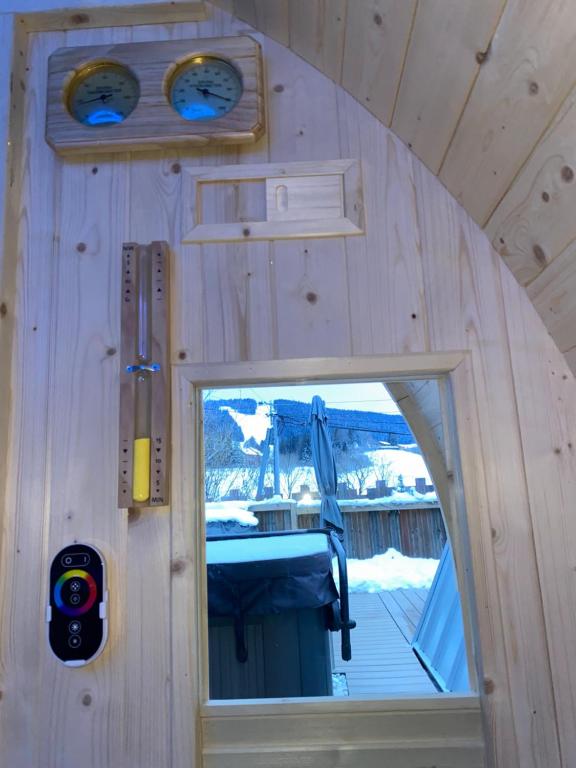 a view of a window in a tiny house at Au-Doux-Altic chalet romantique avec JACUZZI ET SAUNA in Métabief