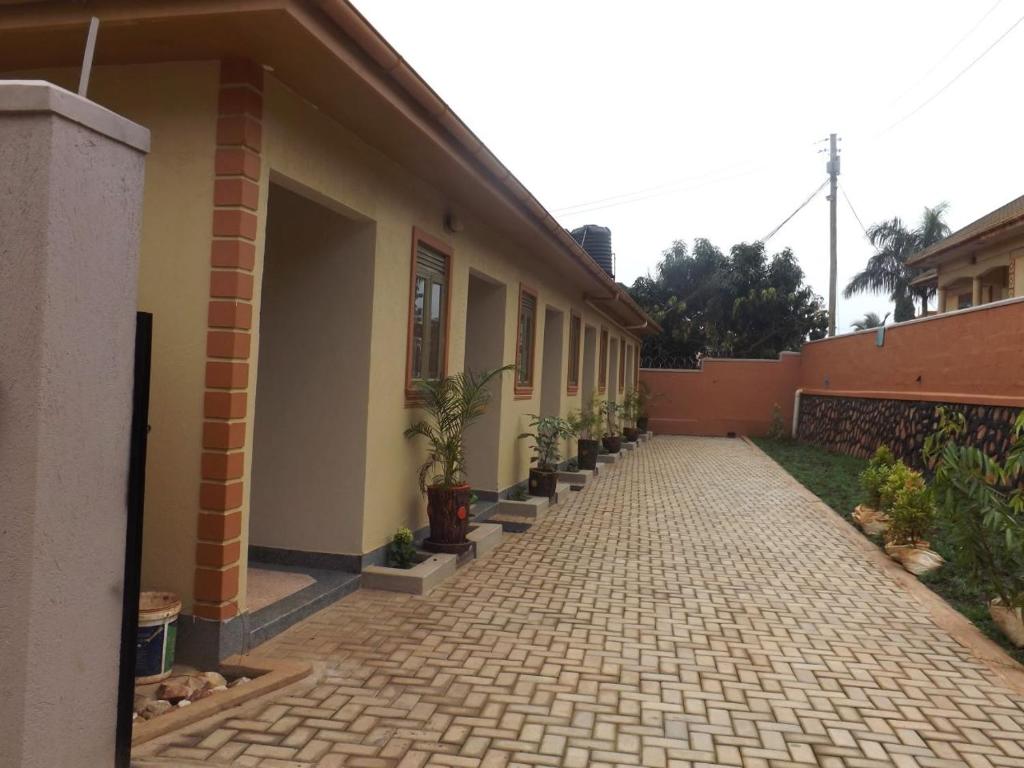 a building with a walkway with potted plants on it at Malaika Furnished Apartments in Kampala