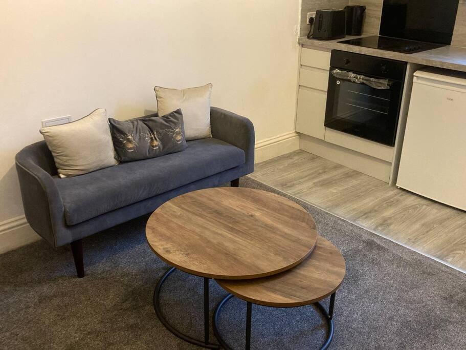a living room with a couch and a table at Riverside by Teil Luxurious one bed Apartment in Preston