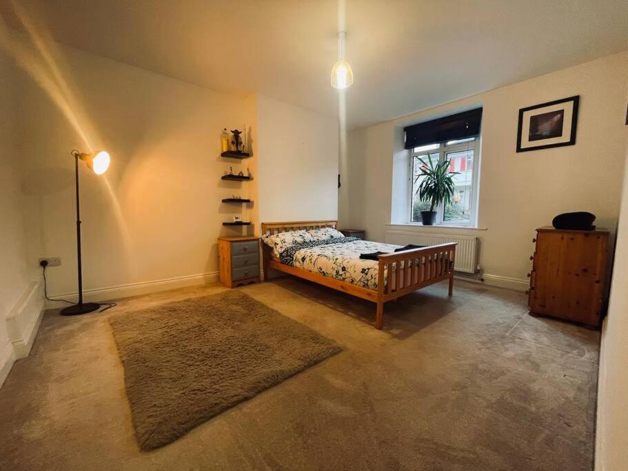 a bedroom with a bed and a window at Ground floor entire costal apartment in Watchet. in Watchet