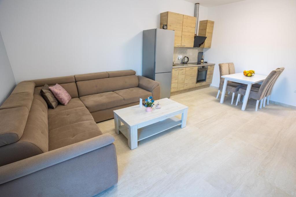 a living room with a couch and a table at Apartmani Lauc in Ljubuški