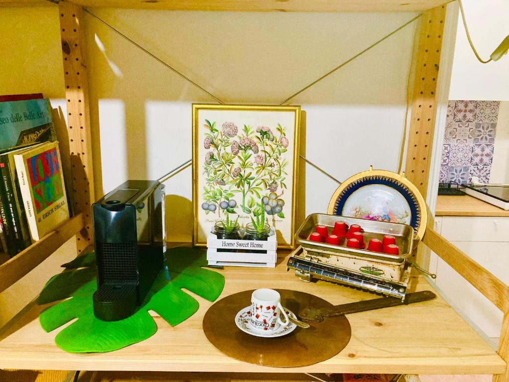 a shelf with a table with a toy house at La Casetta di San Giovanni in Rome