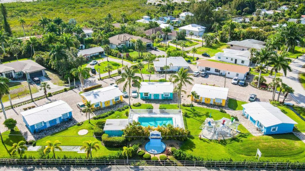 an aerial view of a house with a pool at Cottage Near Beach, Heated Pool, Full Kitchen! in Fort Myers