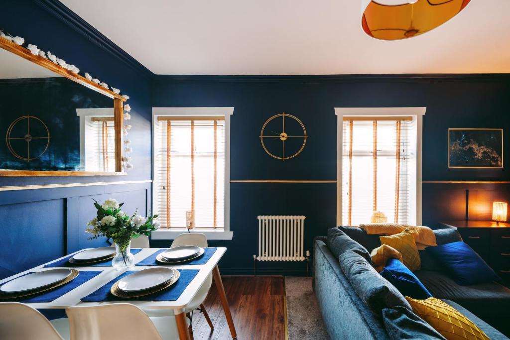 a living room with blue walls and a blue couch at Central Retreat in Cardiff
