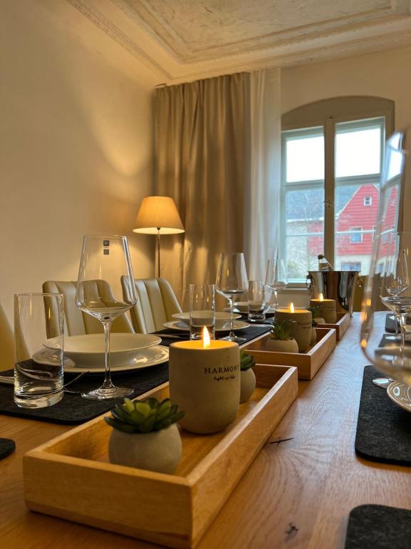 a dining room with a table with candles and chairs at Feine Wohn und Schlafstuben im Herrenhof I UNESCO Welterbe I Parkplatz I Erzgebirge I Waldbühne in Schwarzenberg