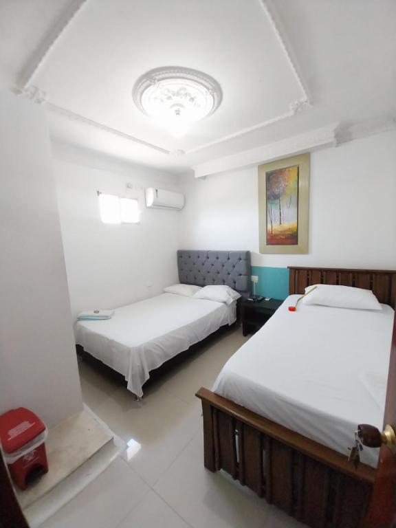 Postel nebo postele na pokoji v ubytování Hotel Sierra Nevada B&B SAS