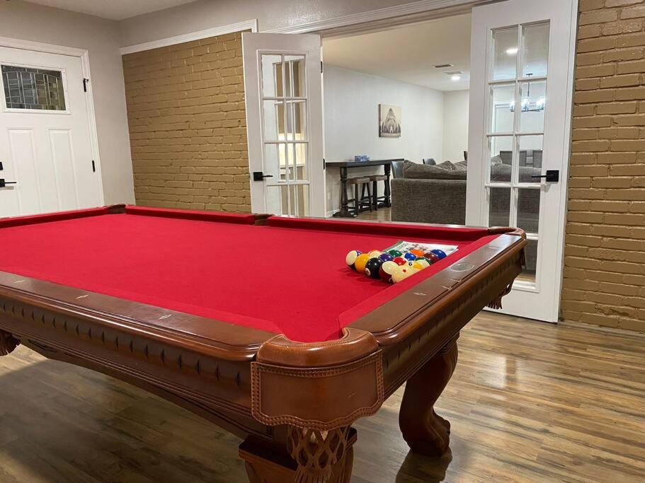 a red pool table in a living room at NEW! Luxury Home in Central McAllen in McAllen
