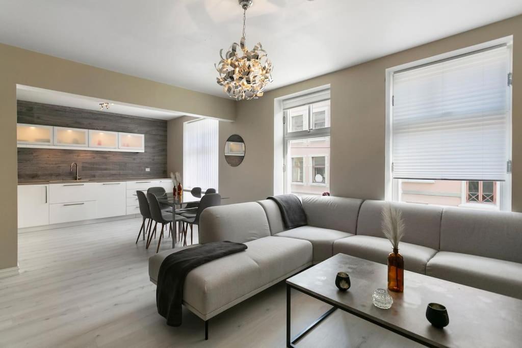 a living room with a couch and a table at Aalesund centrum apartement. in Ålesund