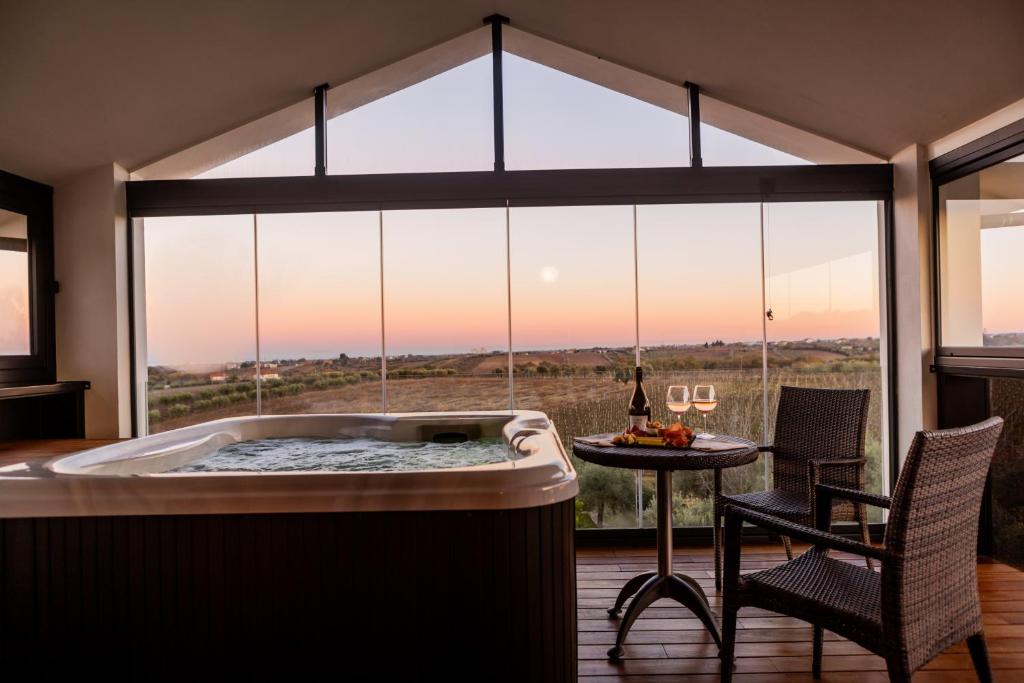 a jacuzzi tub in a room with a view at Magnificat Hotel&Resort in Canosa Sannita