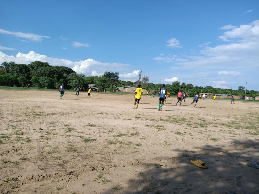 a group of people playing soccer on a field at Muke Village Guest House in Livingstone