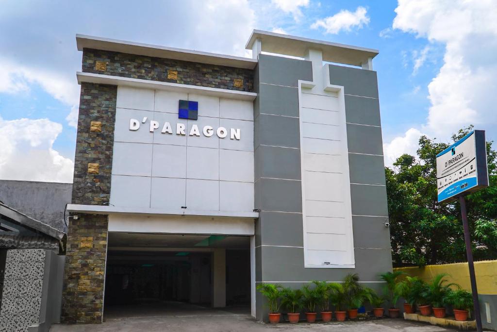 a building with a sign on the side of it at D'Paragon Trikora in Palembang