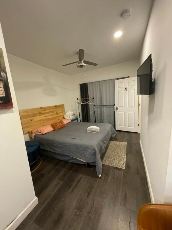 a bedroom with a bed and a flat screen tv at Charming Philly Row 2 Units in Philadelphia