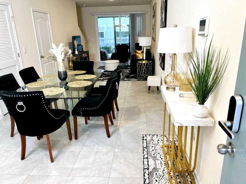 a living room with a table and chairs at Orange Park Townhome Vacation Rental with Patio! in Orange Park