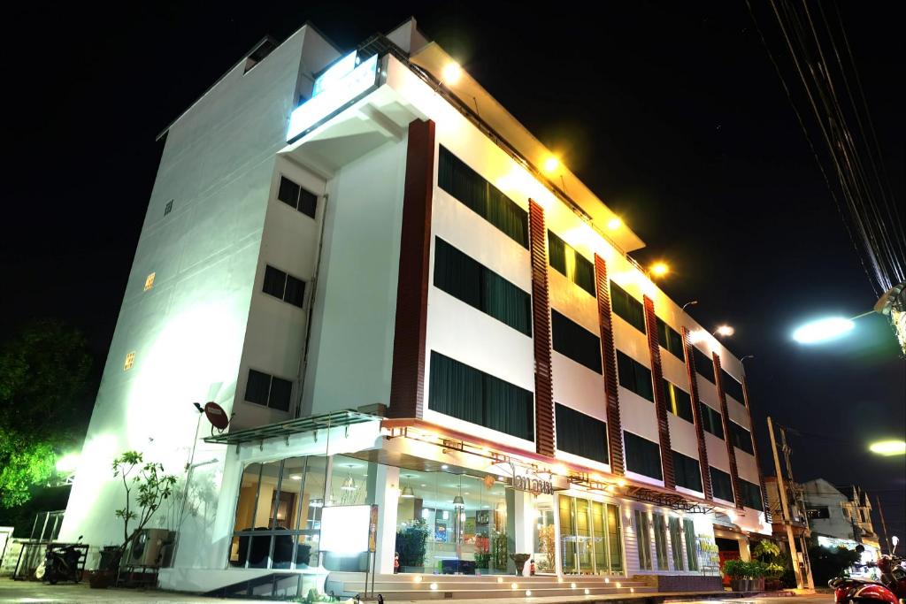 a large white building with lights on it at night at White Inn Nongkhai in Nong Khai