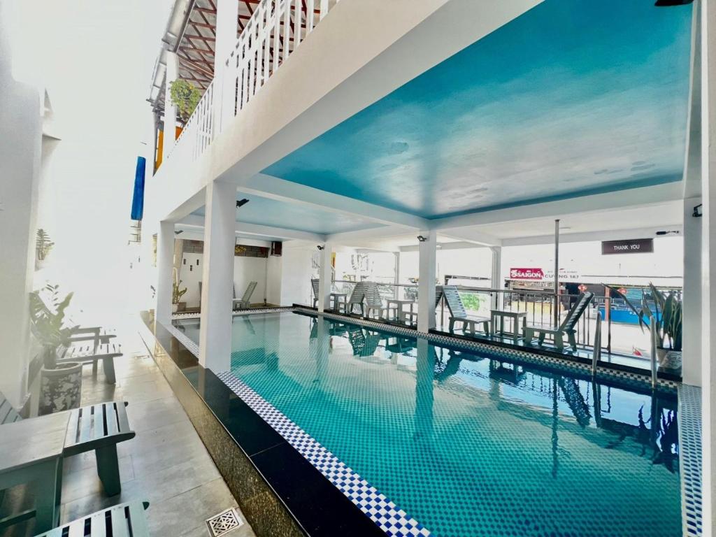 a swimming pool in a building with a view of the ocean at Ocean Valley Hotel in Mui Ne