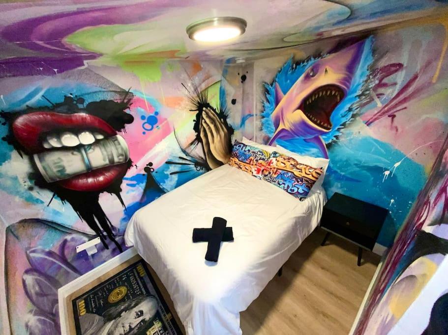 a bedroom with a painting of a bed in a room at Cozy & Colorful Miami Art Canvas w/HotTub & Murals in Miami