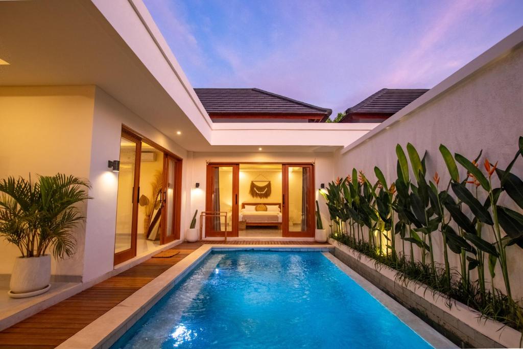 a swimming pool in the middle of a house at Best Place by walking, Beach, Brand NEW Villa, Canggu in Kerobokan