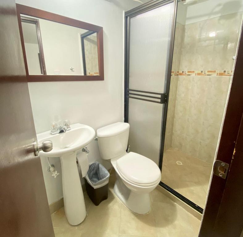 a bathroom with a toilet and a sink and a shower at Hermoso apartamento en San Pablo Guayabal in Medellín