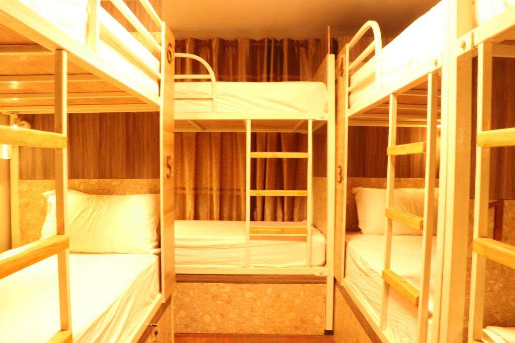 Zimmer mit 4 Etagenbetten und weißen Betten in der Unterkunft Apartment Elegant Kathmandu in Kathmandu
