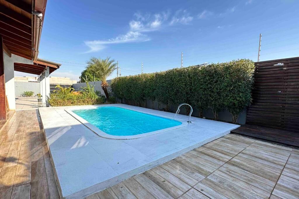 a swimming pool in the backyard of a house at Casa com Piscina (Somente para 4 Hóspedes). in Sinop