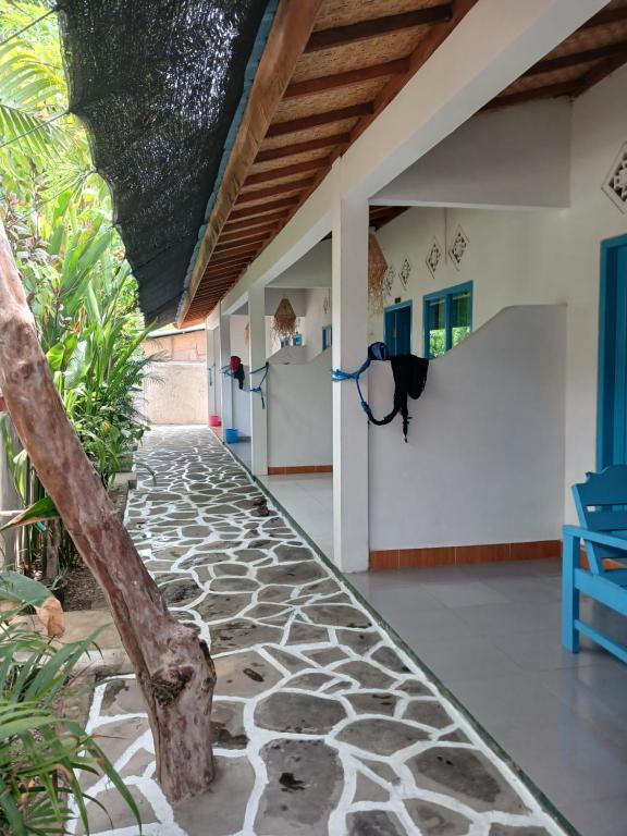 a hallway of a house with a stone walkway at Melbao Homestay in Gili Air