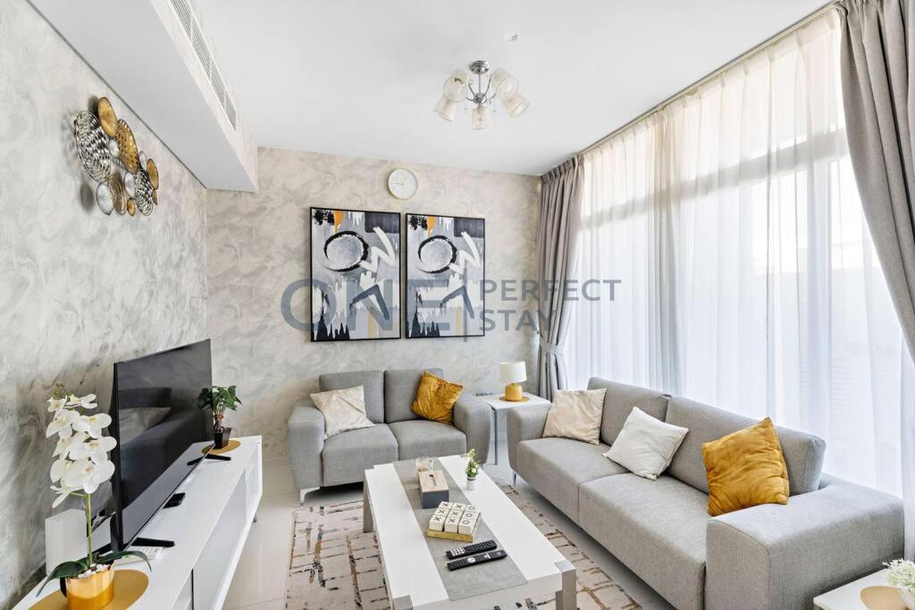 a living room with a couch and a table at Spacious 3BR Townhouse in Mimosa, Damac Hills 2 in Dubai