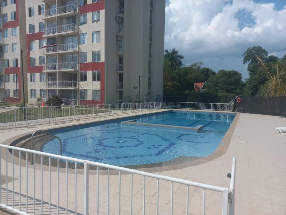 una gran piscina frente a un edificio en Apartamento en Ricaurte, Arrayanes de Peñaliza, en Ricaurte