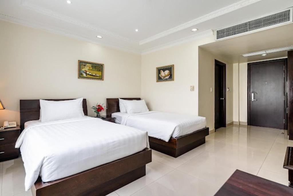 Giường trong phòng chung tại La Bonita Boutique Hotel