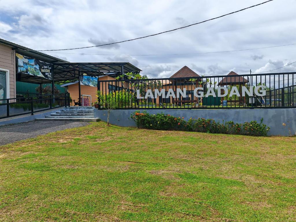 a building with a sign on the side of a fence at Laman Gadang in Johol