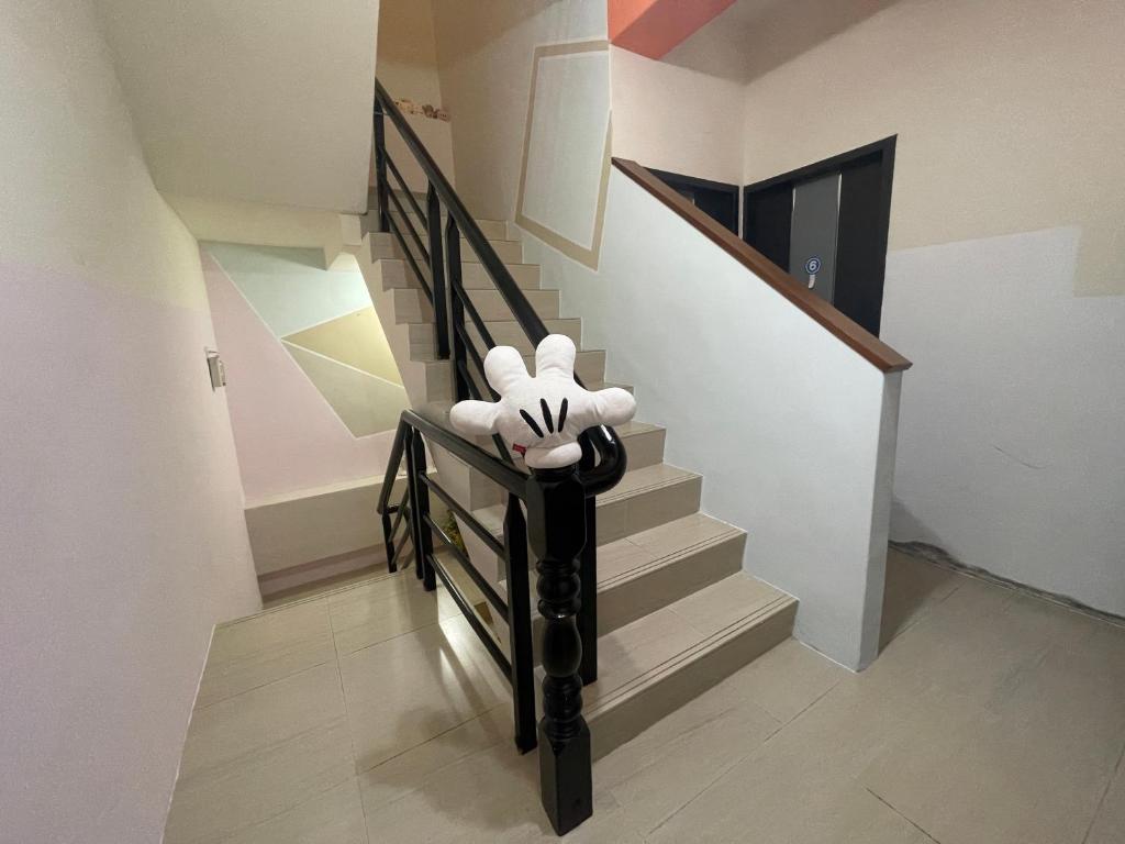 a stuffed animal is sitting on the rail of a staircase at 萩閣民宿Sara&#39;s House走路可到夜市近市區好停車 in Hualien City