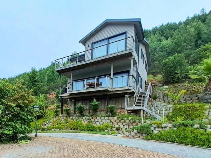a large house on top of a hill at Aquila Chalet Phantom Views in Knysna