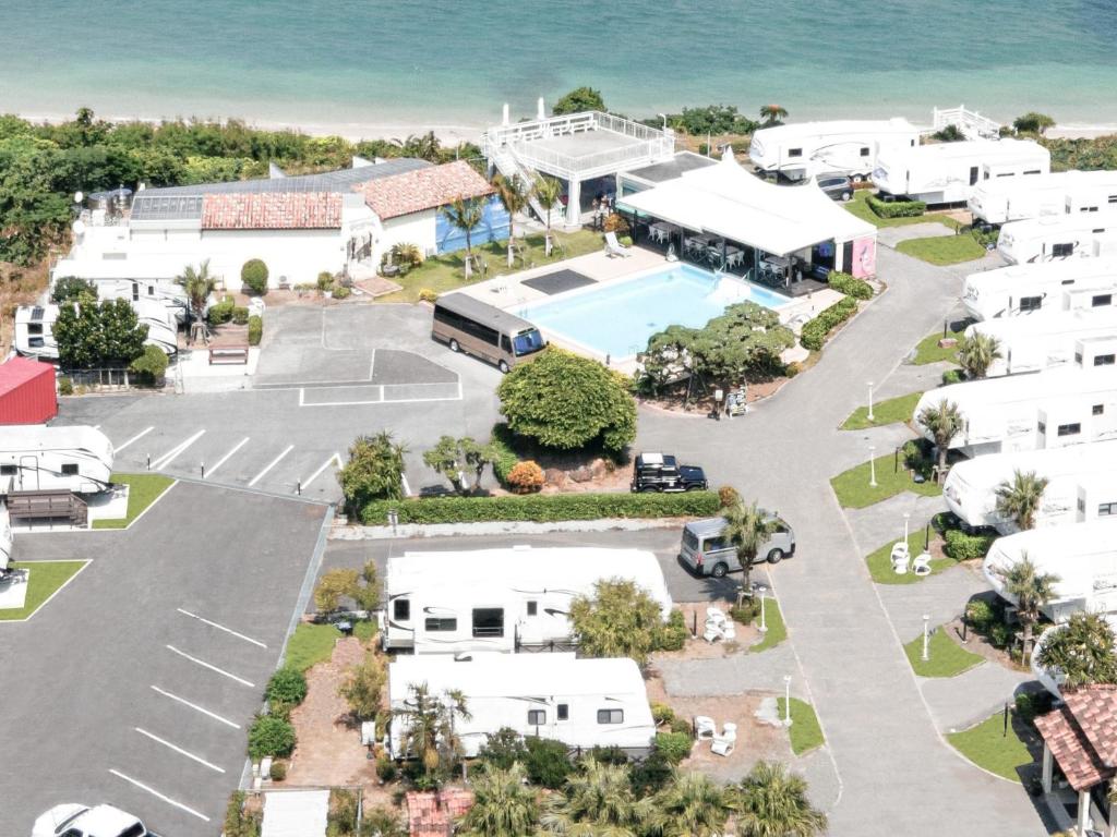 an aerial view of a resort with a tennis court at Wood Pecker Nakijin in Nakijin