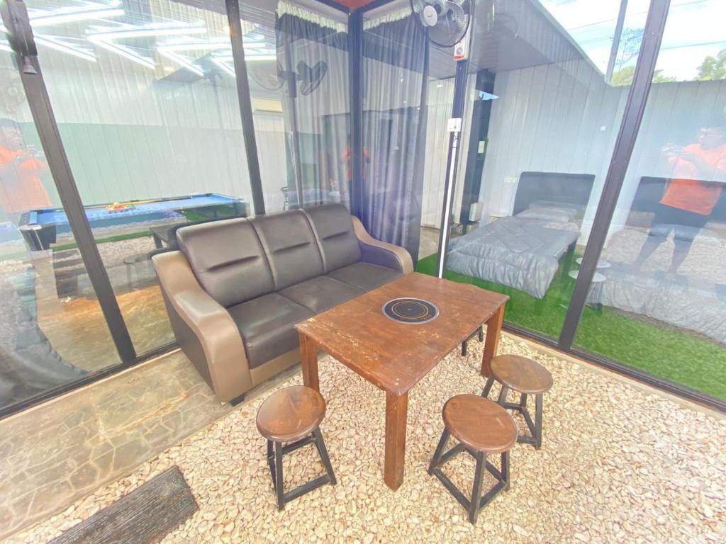 a living room with a couch and a table at IT SWISS GARDEN in Perai