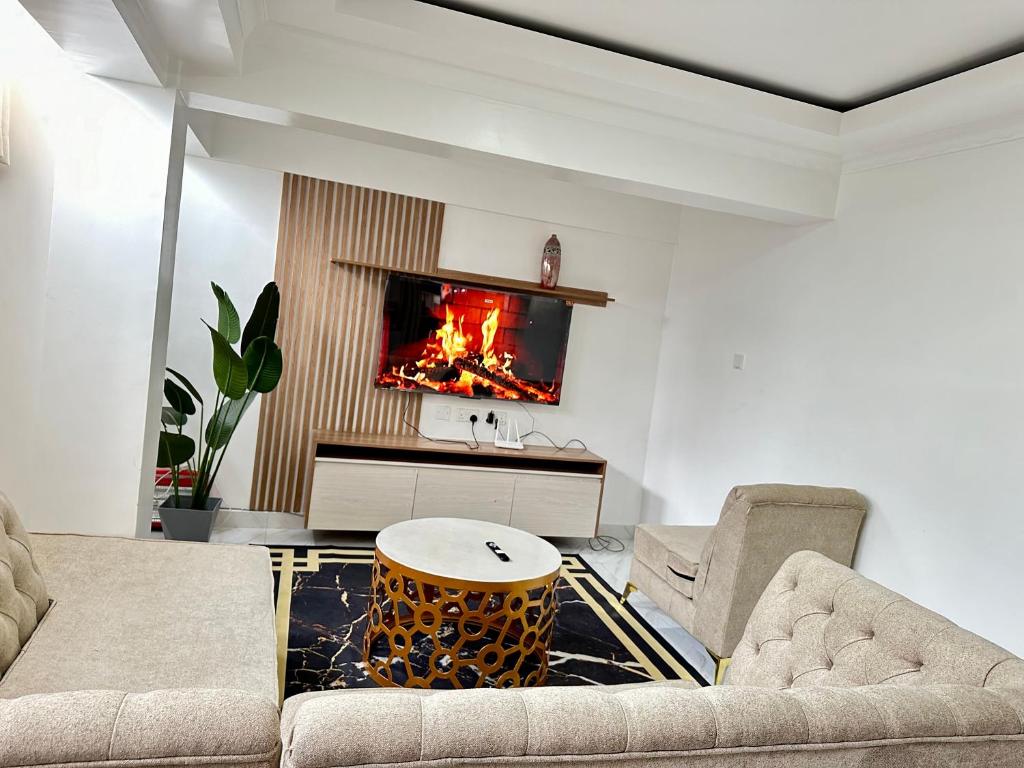 a living room with a couch and a fireplace at Regency Stays III in Eldoret