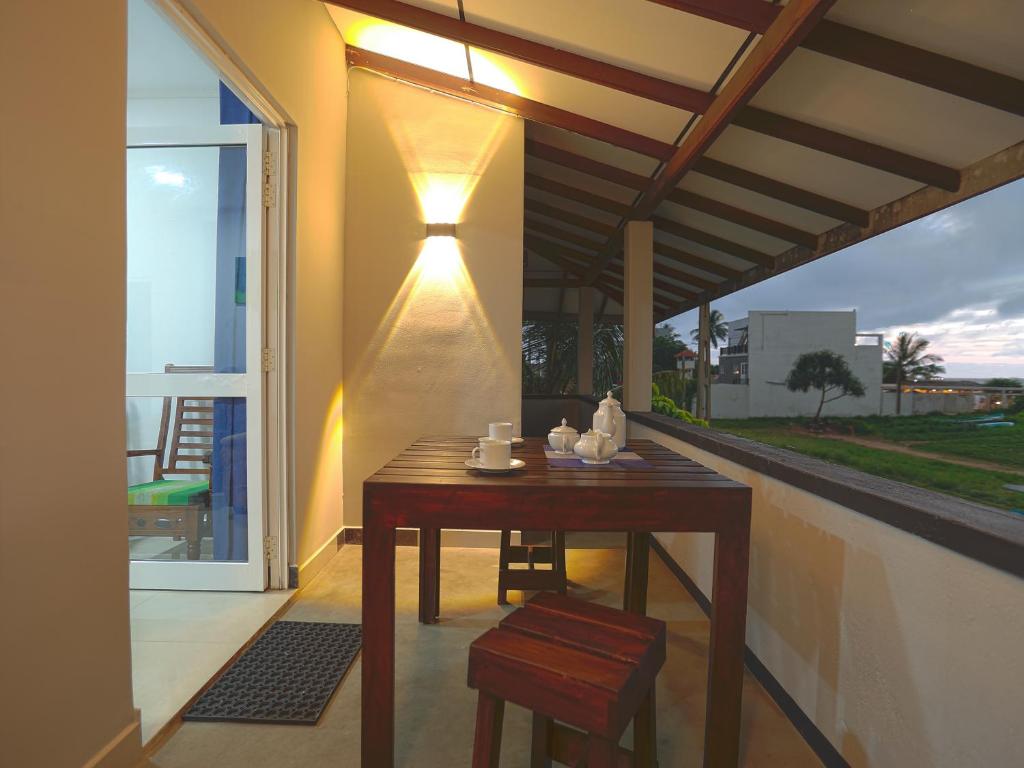 a table with a light on the side of a house at Sea View Villa in Hikkaduwa