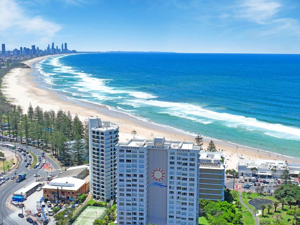 a view of a beach with a building and the ocean at Burleigh Beach Tower in Gold Coast