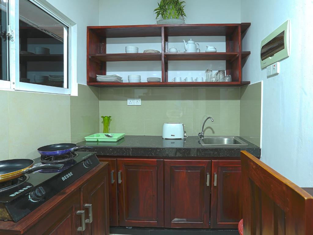 a kitchen with a sink and a counter top at Sea View Villa in Hikkaduwa