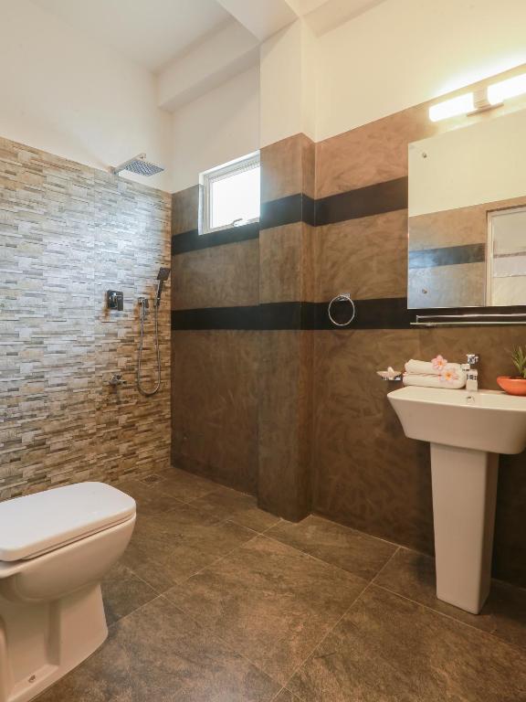 a bathroom with a toilet and a sink at Sea View Villa in Hikkaduwa