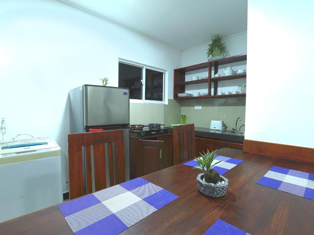 a kitchen with a table and a tv in it at Sea View Villa in Hikkaduwa