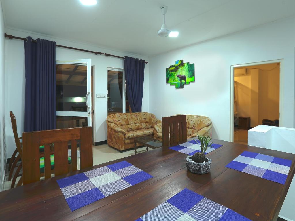 a living room with a dining room table and a couch at Sea View Villa in Hikkaduwa