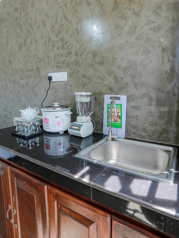 a kitchen counter with a sink and a blender at Sea View Villa in Hikkaduwa